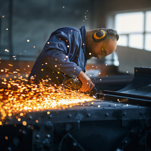 Weld preparation grinding with sparks on fabricated steel